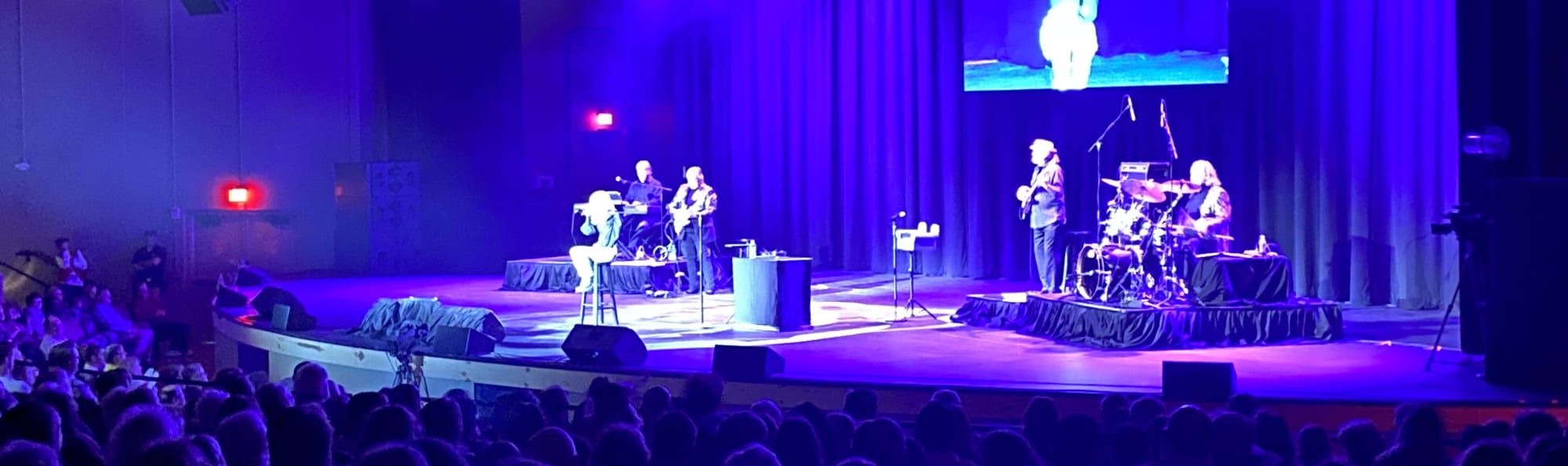 signer on stage in chair washed out by the lights Jackson