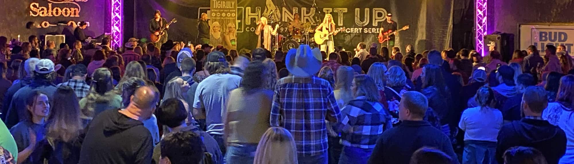 country concert with fans wearing cowboy hats Jackson